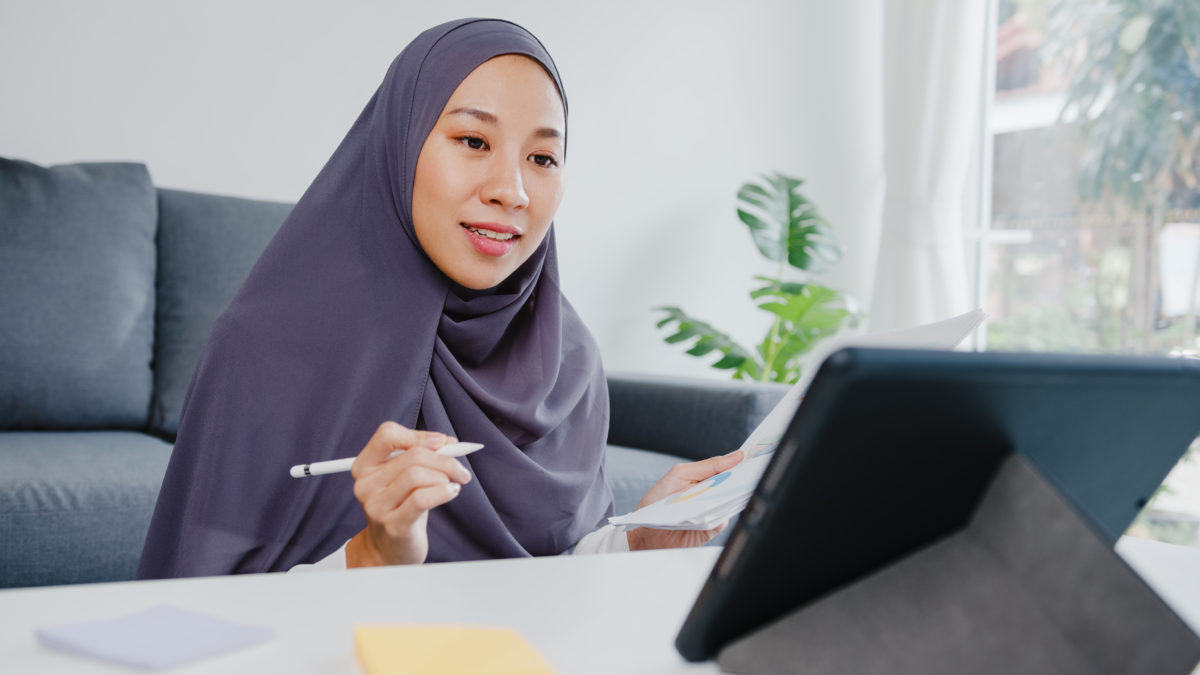 Muslim woman in a head scarf participating in a virtual SKP