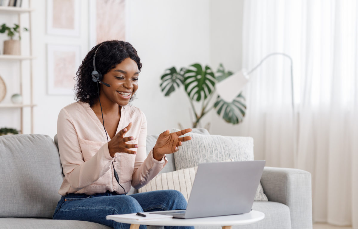 Black woman engaging with others while attending a virtual event
